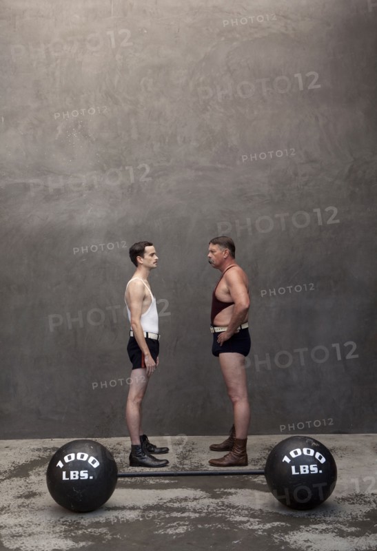 Caucasian weight lifters examining each other