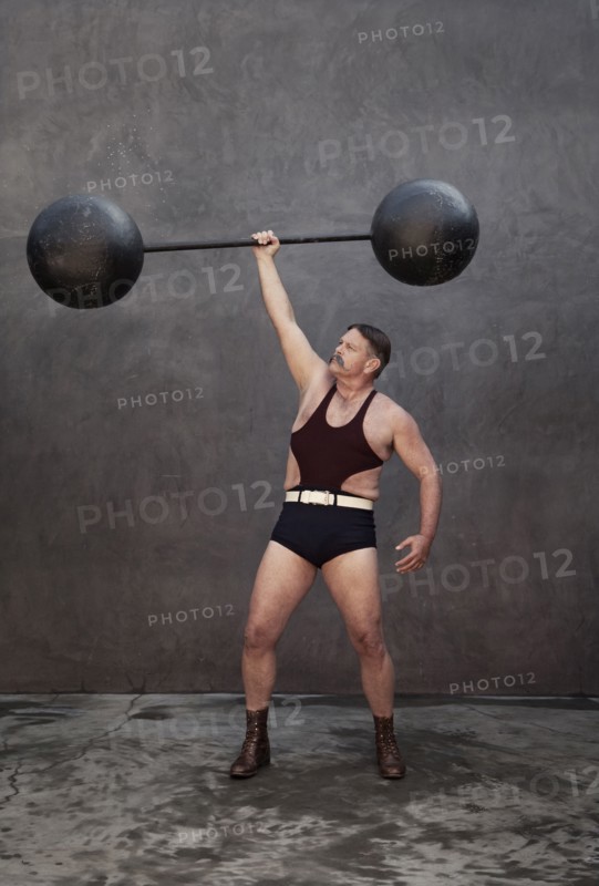 Caucasian weight lifter holding weights