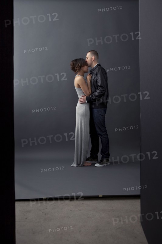 Couple kissing in studio