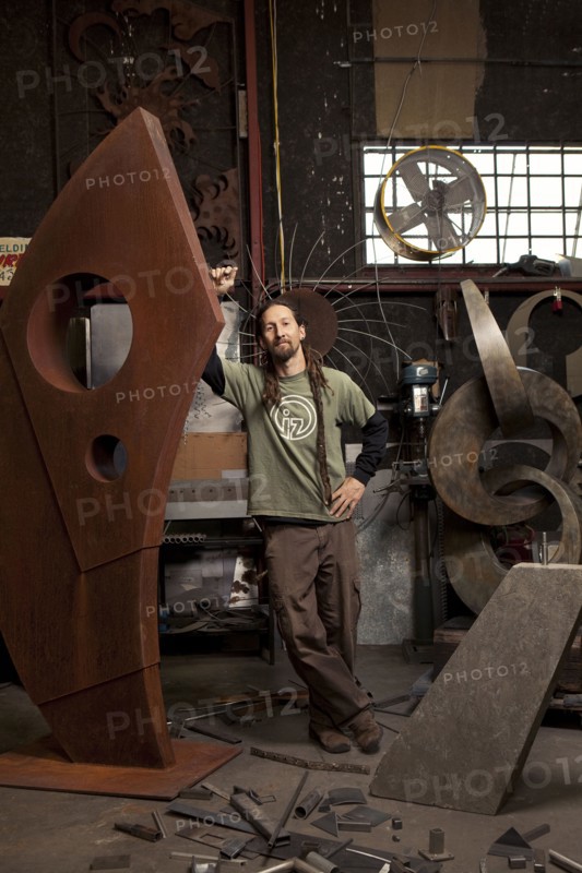 Caucasian artist standing in studio
