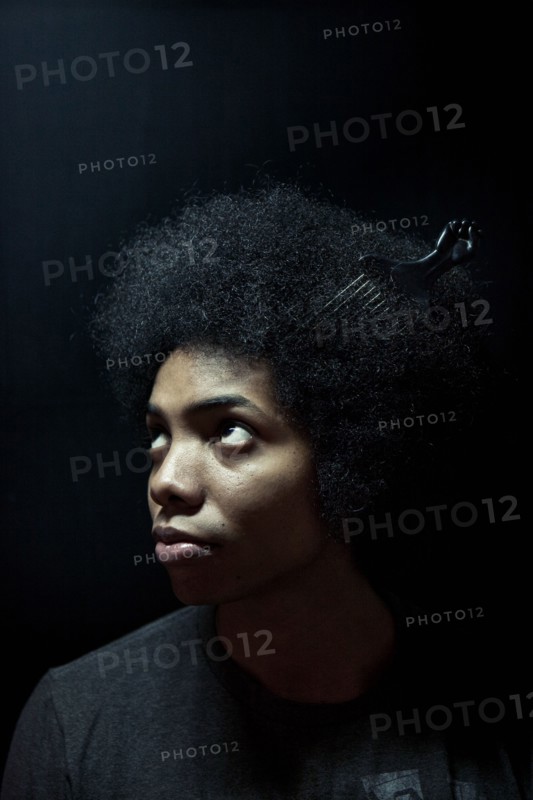 African American man wearing comb in afro hairstyle