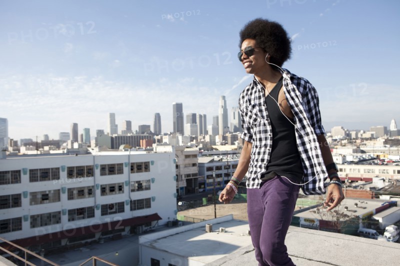 African American man standing on urban rooftop