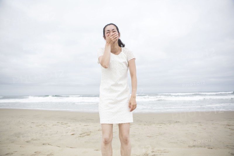 Woman laughing on beach