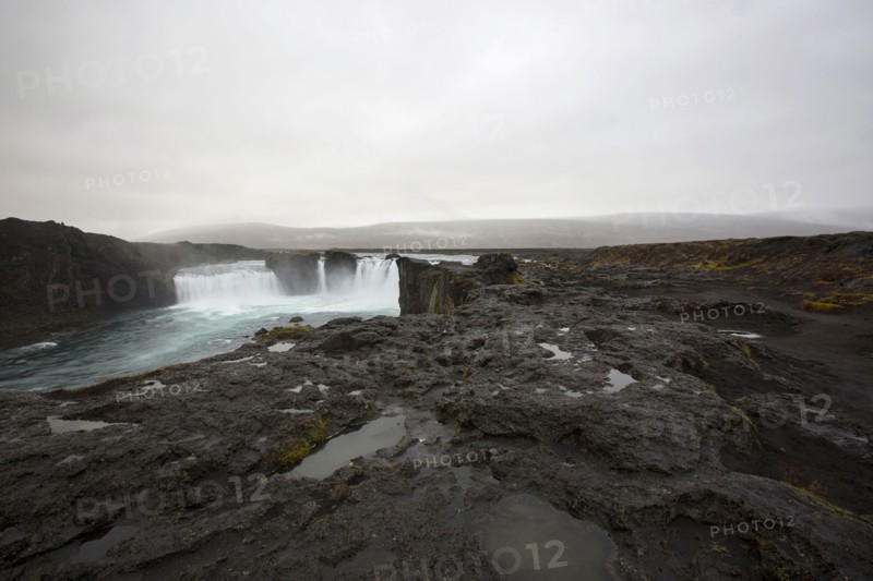 Rock formation cliffs near remote waterfall