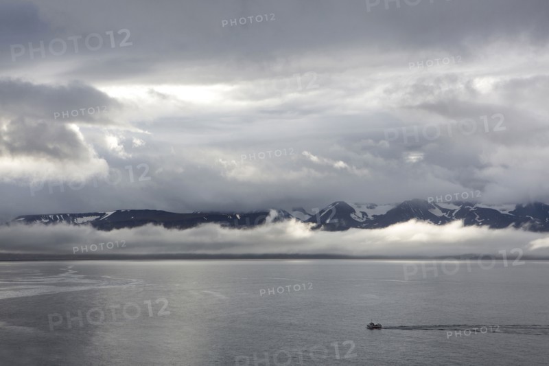 Aerial view of seascape and remote mountains