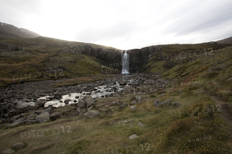 Waterfall and rocky stream in remote field