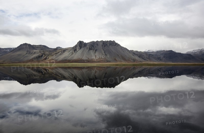 Mountains reflecting in still lake