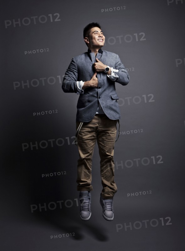 Chinese man wearing jacket and jumping