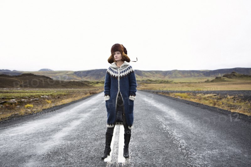 Caucasian woman standing in middle of road