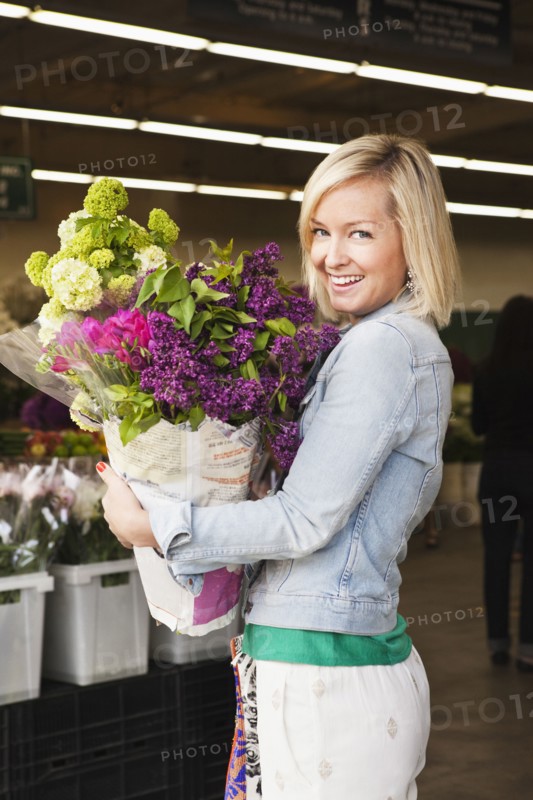 Caucasian woman carrying bouquet of flowers