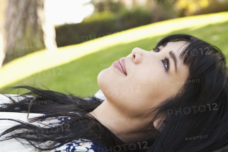 Smiling woman laying in grass