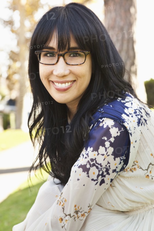 Smiling woman sitting outdoors