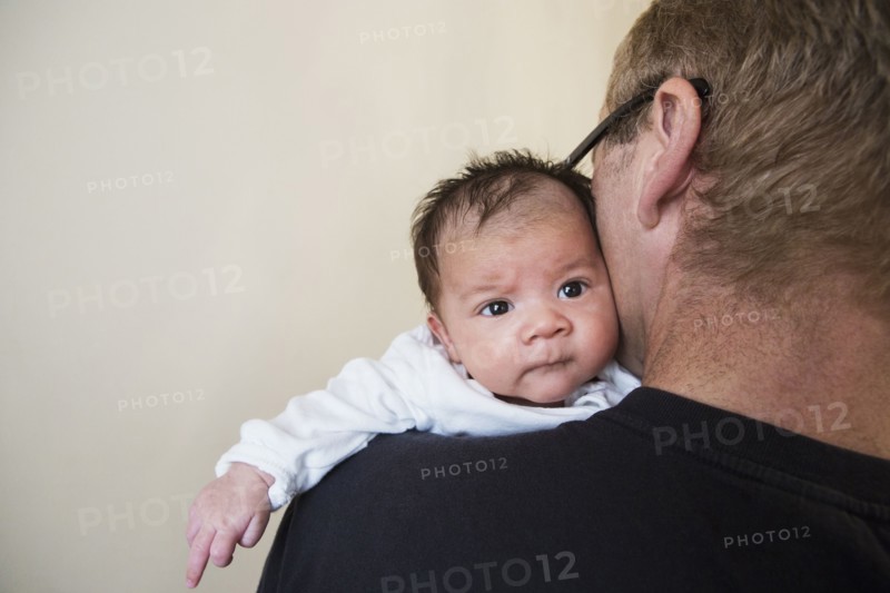 Close up of father holding mixed race baby