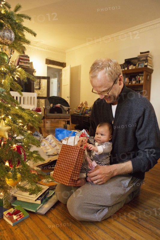 Father and baby boy opening Christmas gifts