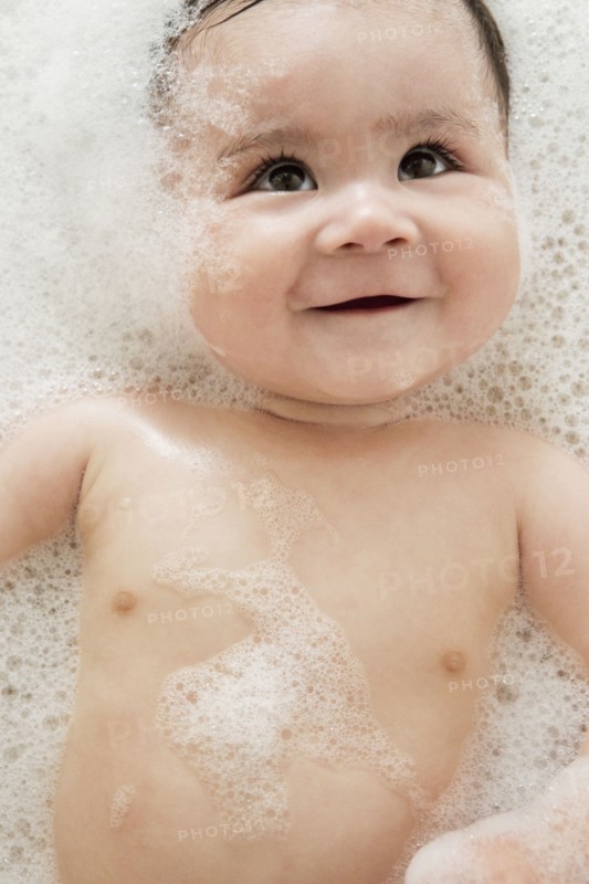 Close up of mixed race baby in bubble bath