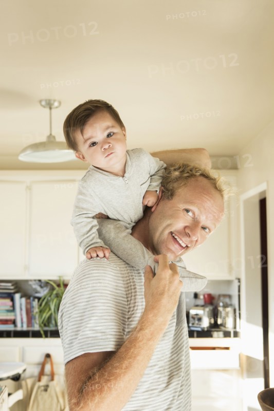 Father carrying baby son on shoulders