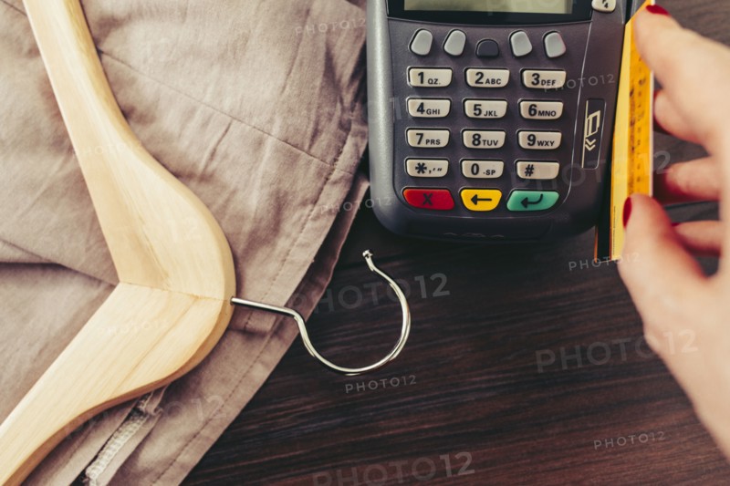 Woman swiping credit card through credit card reader