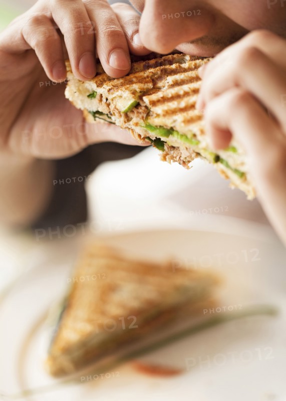 Close up of woman eating sandwich