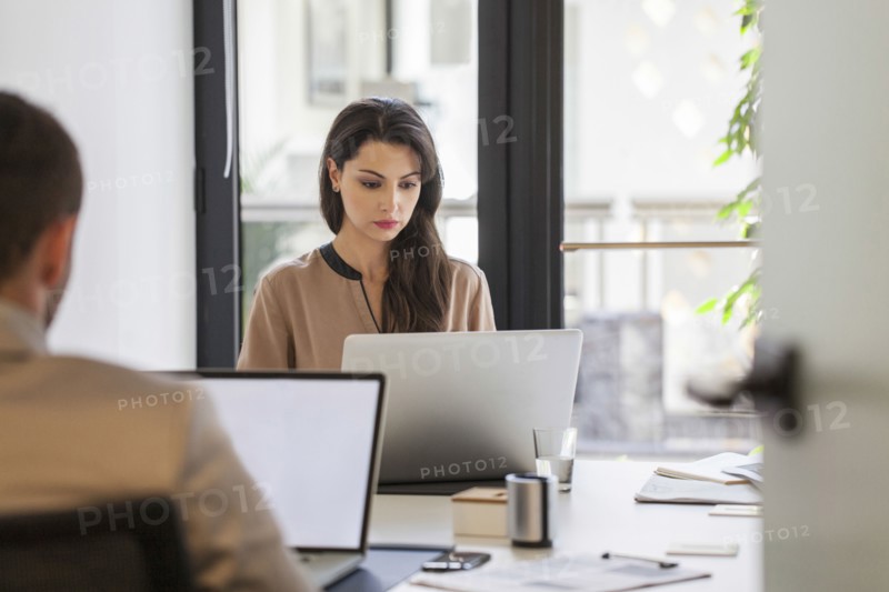 Caucasian business people working at desks in office
