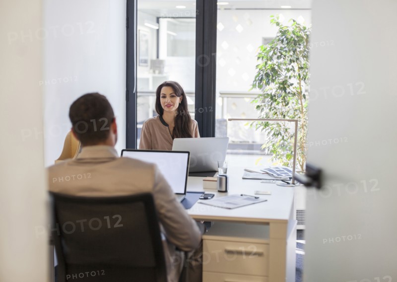 Caucasian business people working at desks in office