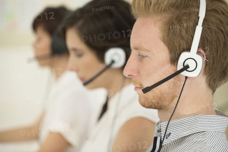Close up of business people wearing headsets