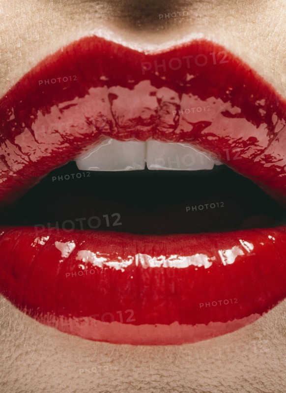 Close up of mouth of woman wearing red lipstick