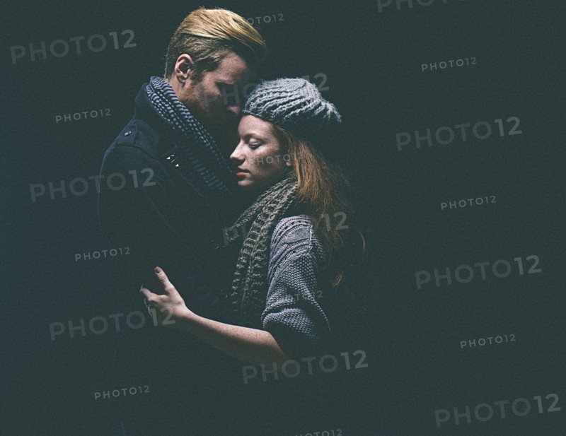 Couple wearing warm clothing hugging
