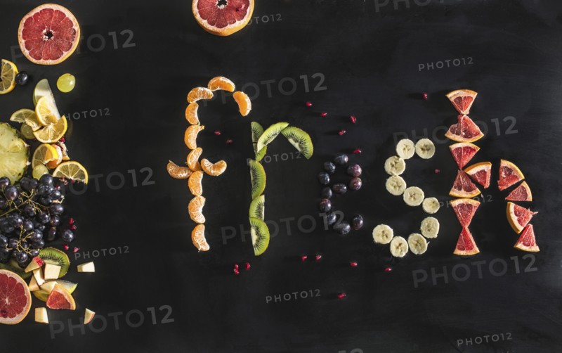 Close up of the word fresh written with sliced fruit