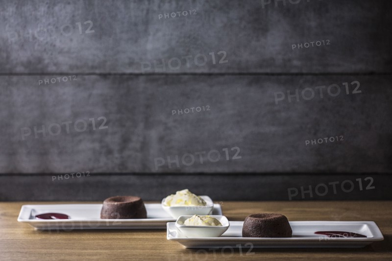 Platters of chocolate souffle dessert with ice cream and sauce