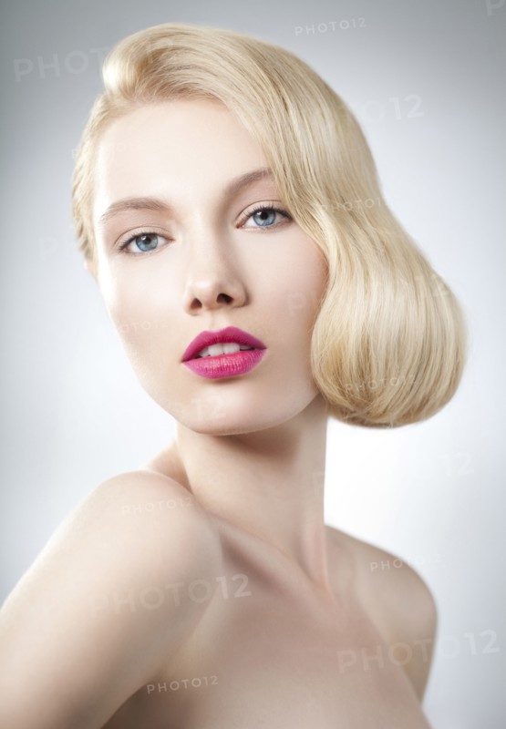 Caucasian woman with glamorous hairstyle and makeup