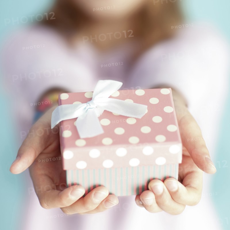 Close up of girl holding wrapped gift