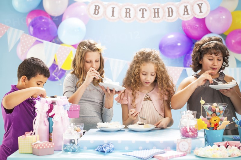 Children eating cake at birthday party
