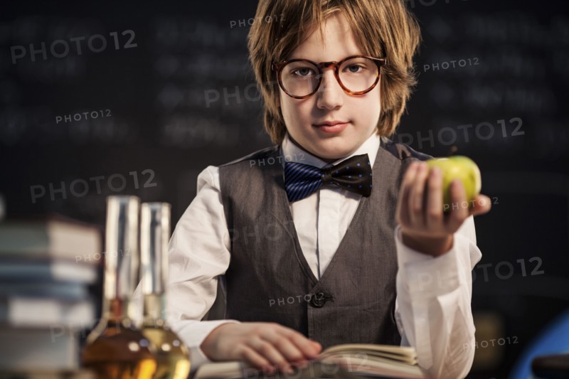Student holding apple and studying