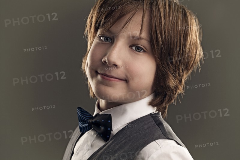 Smiling boy wearing dress shirt and bow tie
