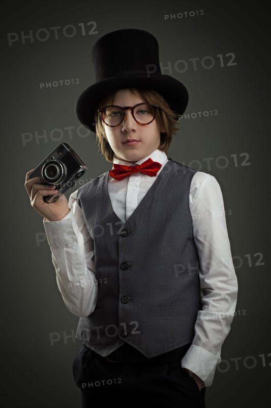 Boy in top hat photographing with vintage camera