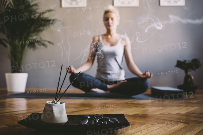 Caucasian woman meditating in yoga studio