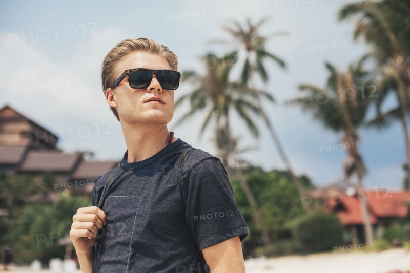 Caucasian man walking on beach