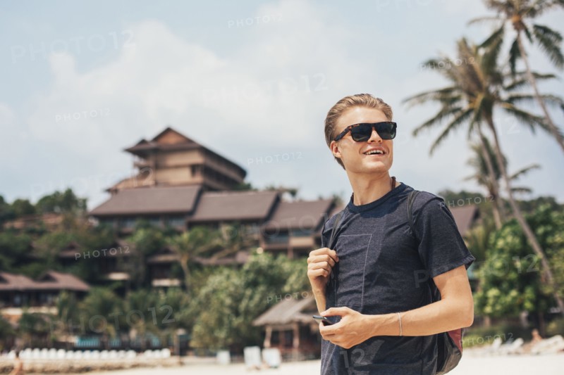 Caucasian man walking on beach