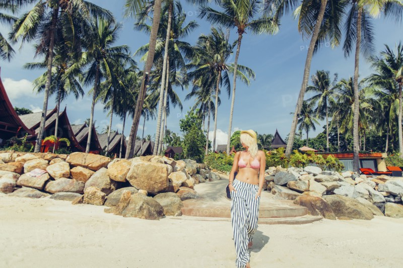 Caucasian woman walking on beach