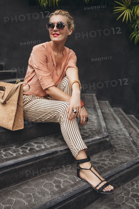Caucasian woman sitting on stairs