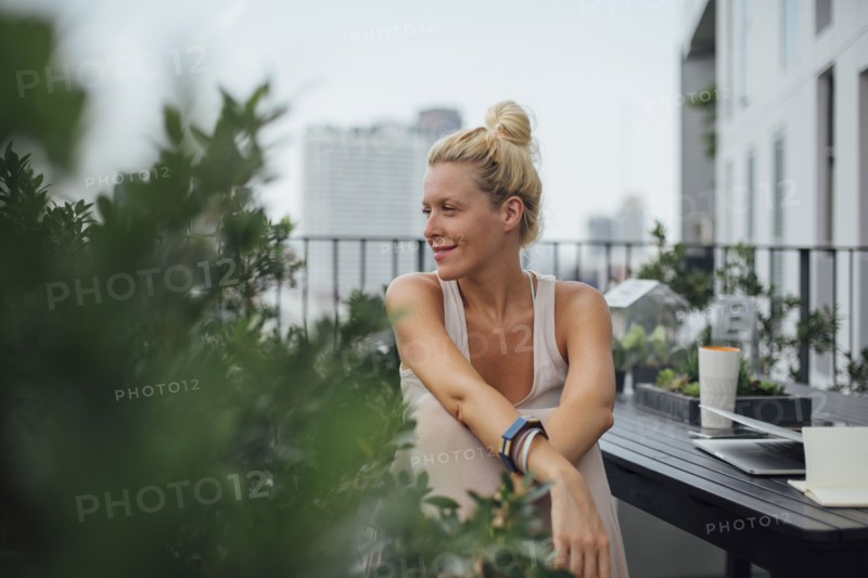 Caucasian woman sitting on balcony