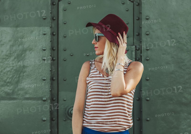 Caucasian woman in hat and sunglasses
