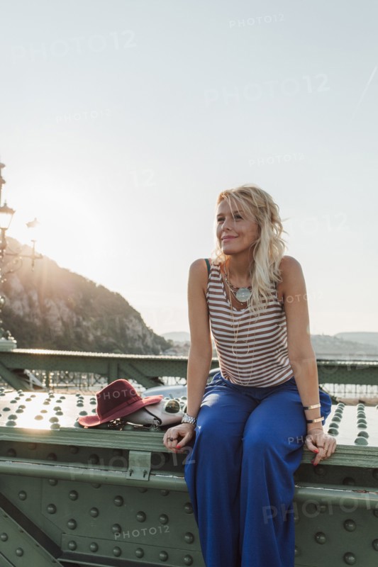 Caucasian woman sitting on bridge
