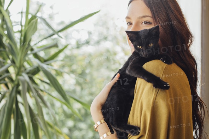 Caucasian woman holding kitten