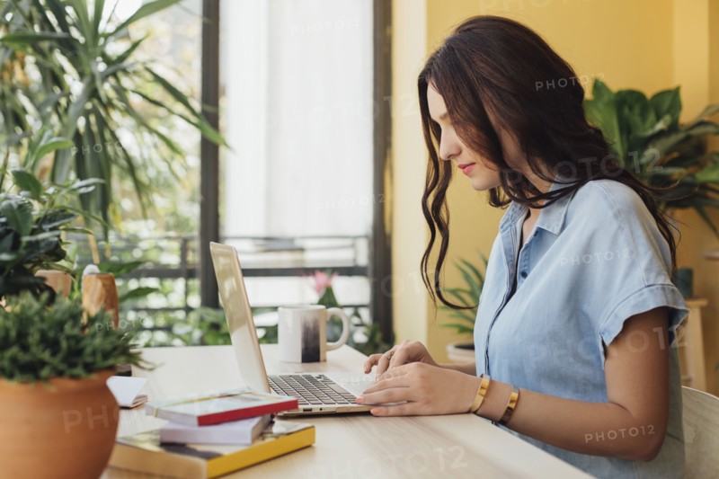 Caucasian woman using laptop at desk