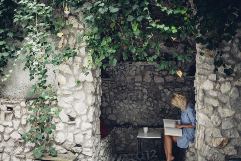 Woman sitting in stone patio