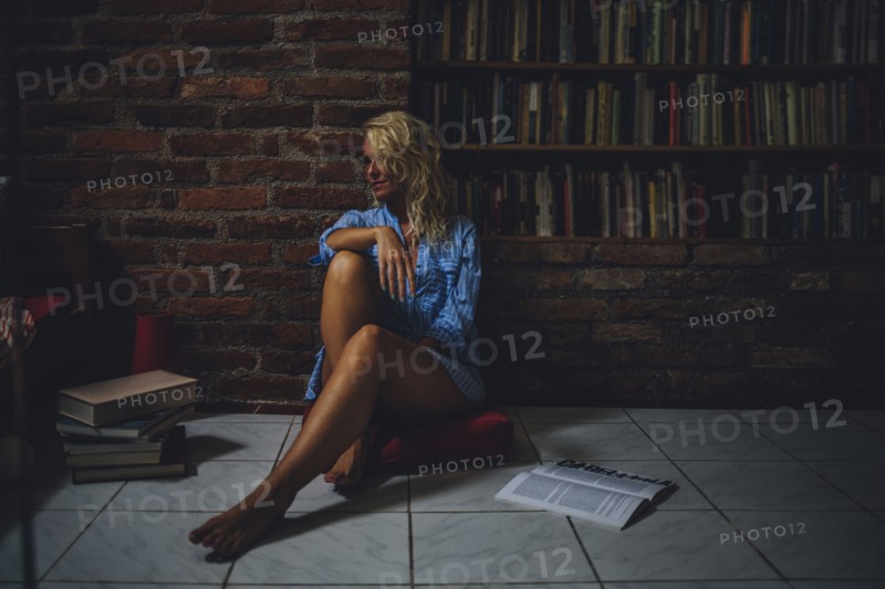 Smiling woman sitting on living room floor