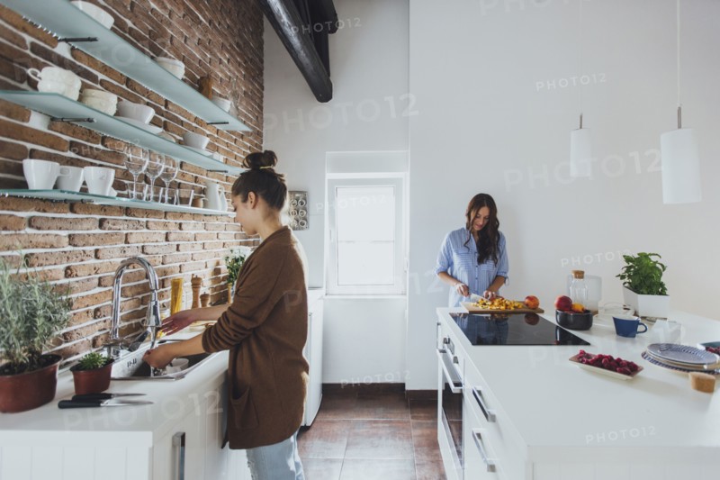 Caucasian women cooking in kitchen