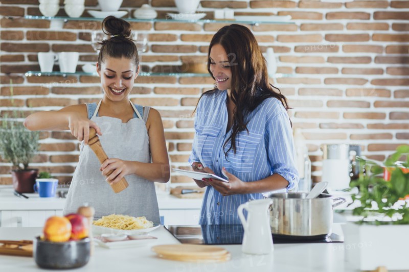 Caucasian women cooking pasta in kitchen