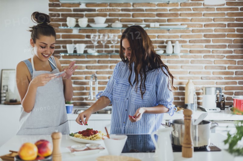Caucasian women cooking pasta in kitchen